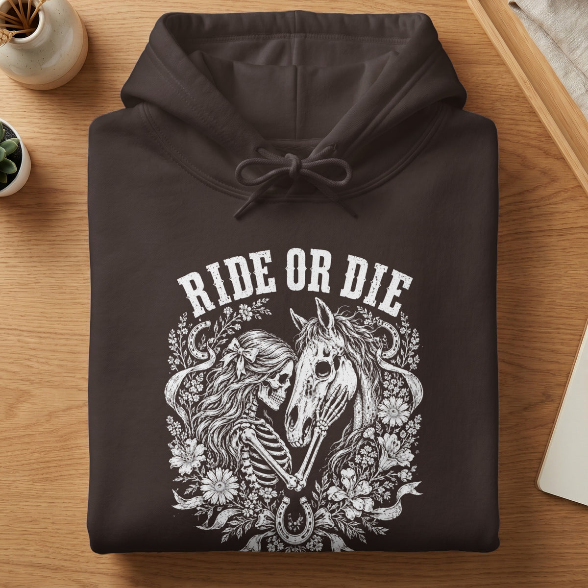 Brown hoodie with "Ride or Die" text and skeleton with horse and floral design.