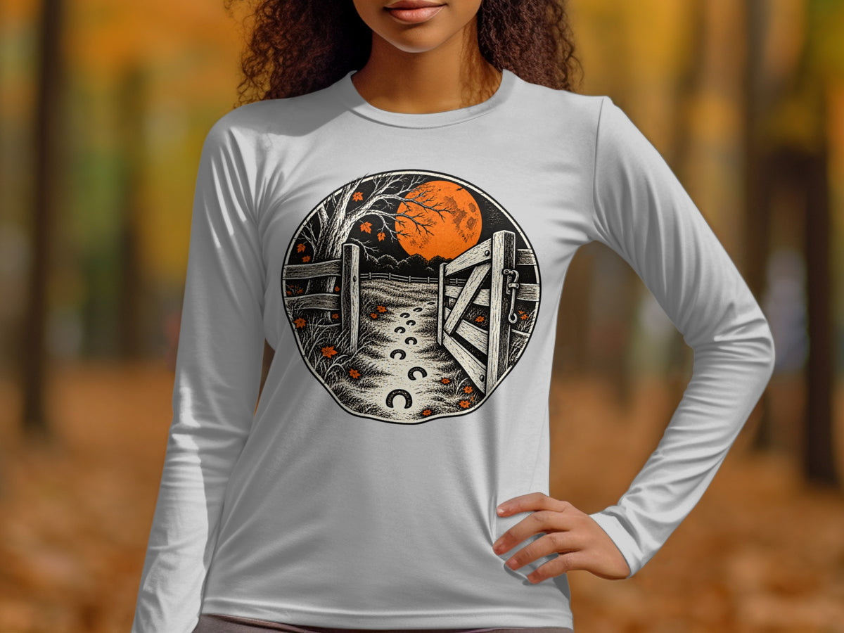Circular graphic on white long-sleeve shirt: open gate, moon, tree, footprints, leaves.