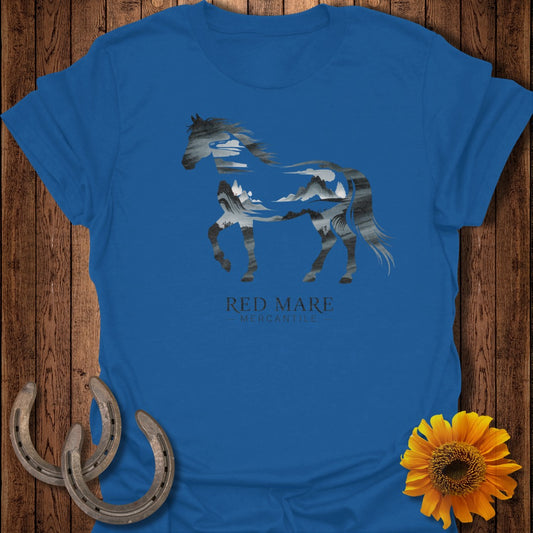 Blue t-shirt with a horse silhouette filled with a mountain landscape.