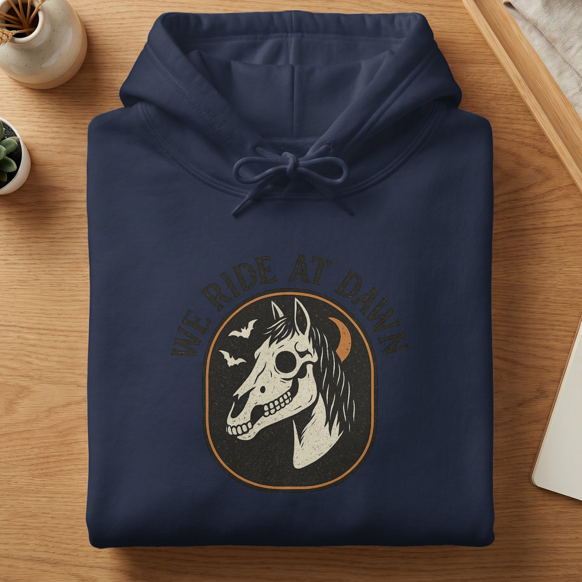 Navy hoodie with a "We Ride At Dawn" graphic featuring a horse skull.