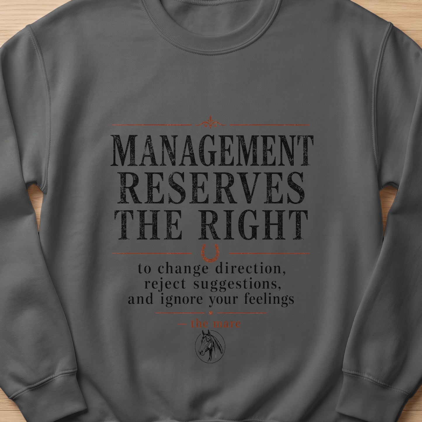 Dark grey sweatshirt with "Management Reserves The Right to change direction, reject suggestions, and ignore your feelings" text.
