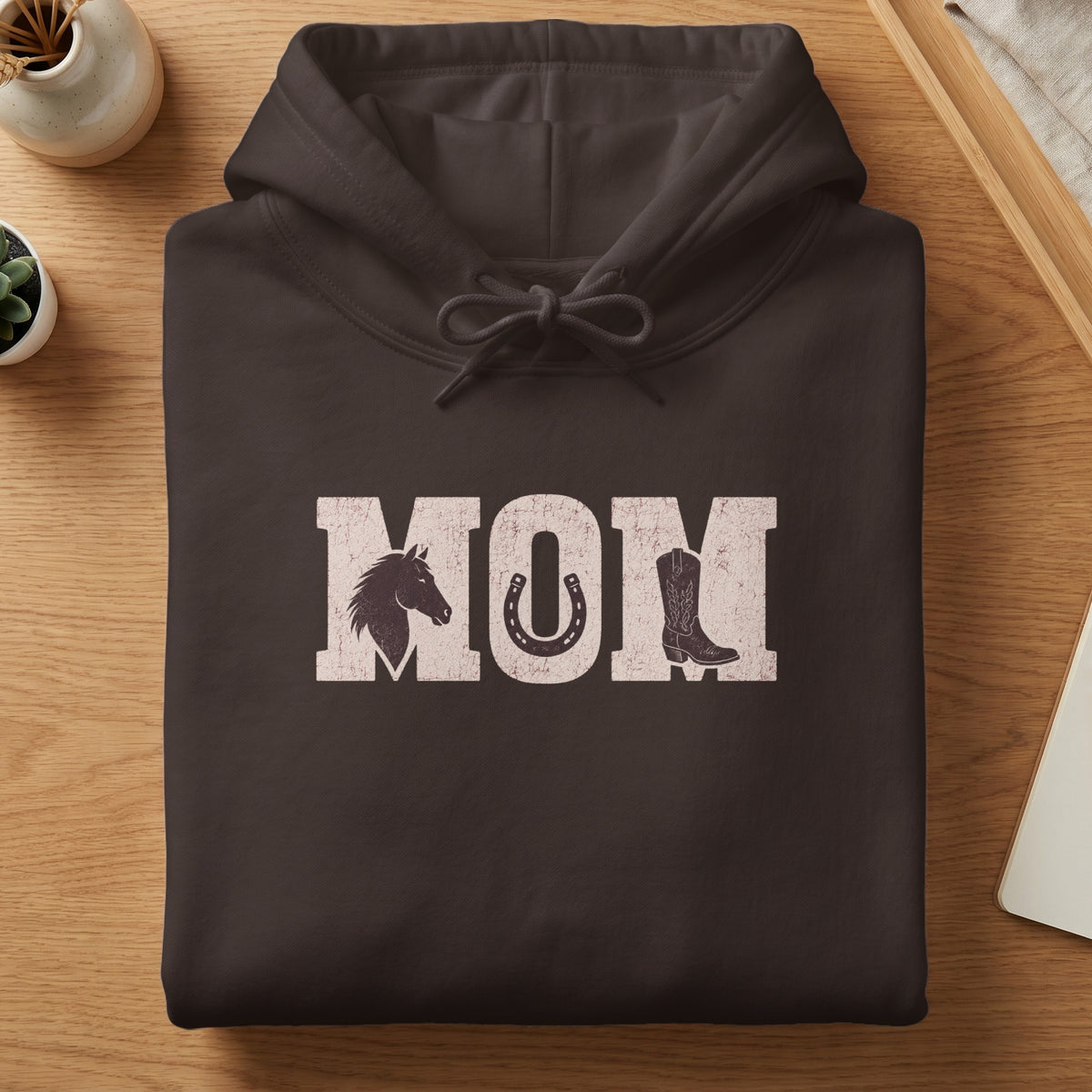 Brown hoodie with "MOM" text featuring horse, horseshoe, and cowboy boot graphics.