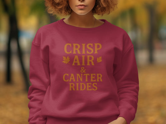 Maroon sweatshirt with "Crisp Air & Canter Rides" text in gold.