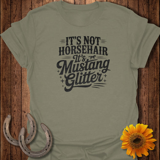 Olive green t-shirt with "It's Not Horsehair, It's Mustang Glitter" text.