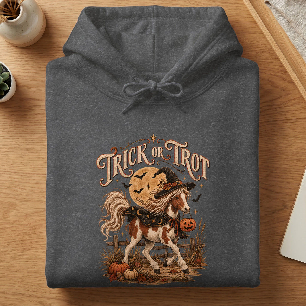 Hoodie with "Trick or Trot" text and a horse in a witch hat holding a pumpkin.