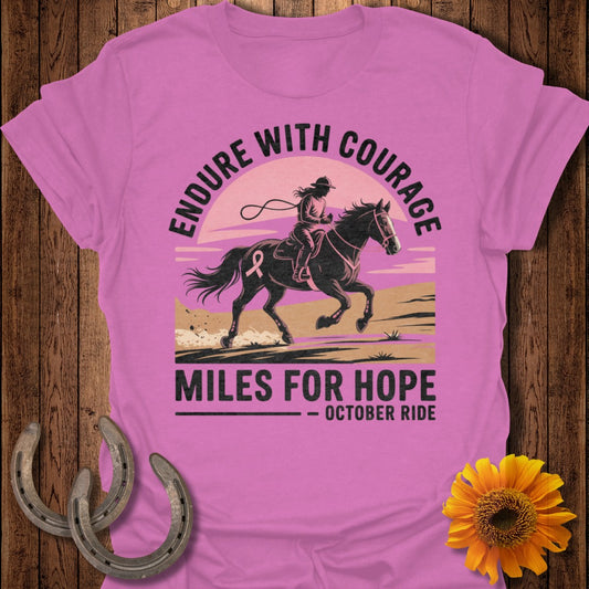 Pink t-shirt with graphic of rider on horse, "Endure With Courage" and "Miles For Hope - October Ride" text.