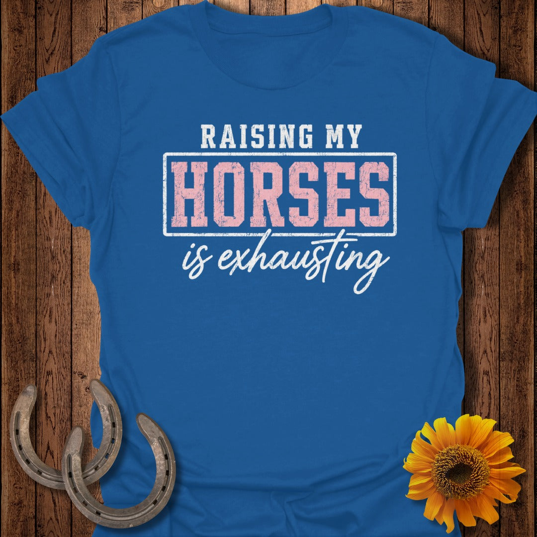 Royal blue t-shirt with "Raising My Horses is Exhausting" text and horseshoes.