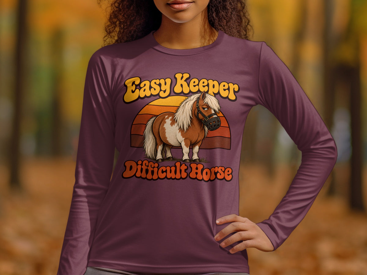"Easy Keeper Difficult Horse" text on a long-sleeve shirt featuring a pony.