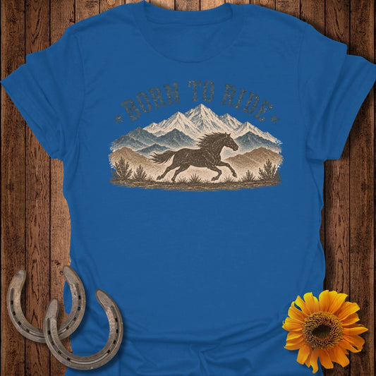 Blue t-shirt with "Born to Ride" text and running horse in mountain landscape.
