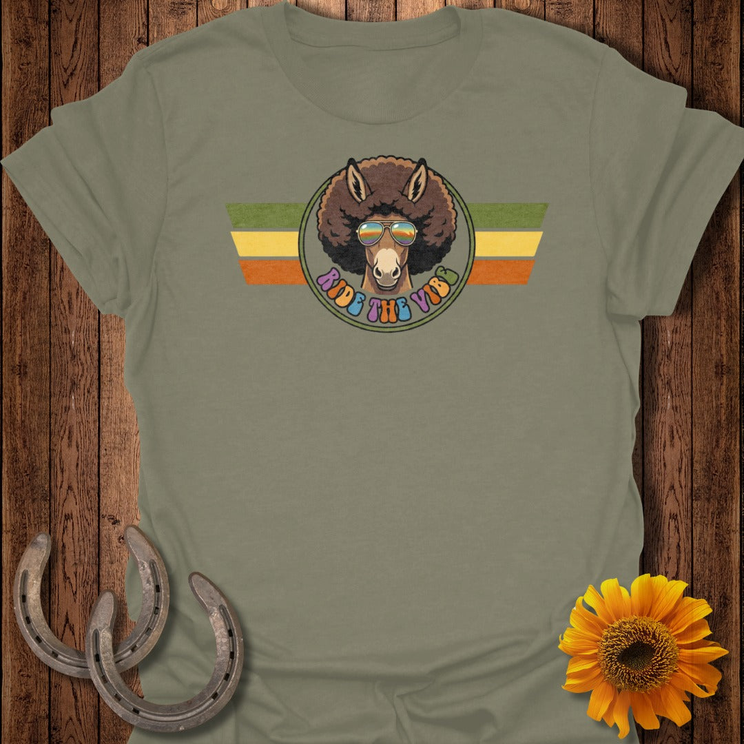 Donkey with sunglasses and afro on striped background, "Ride the Vibes" text.