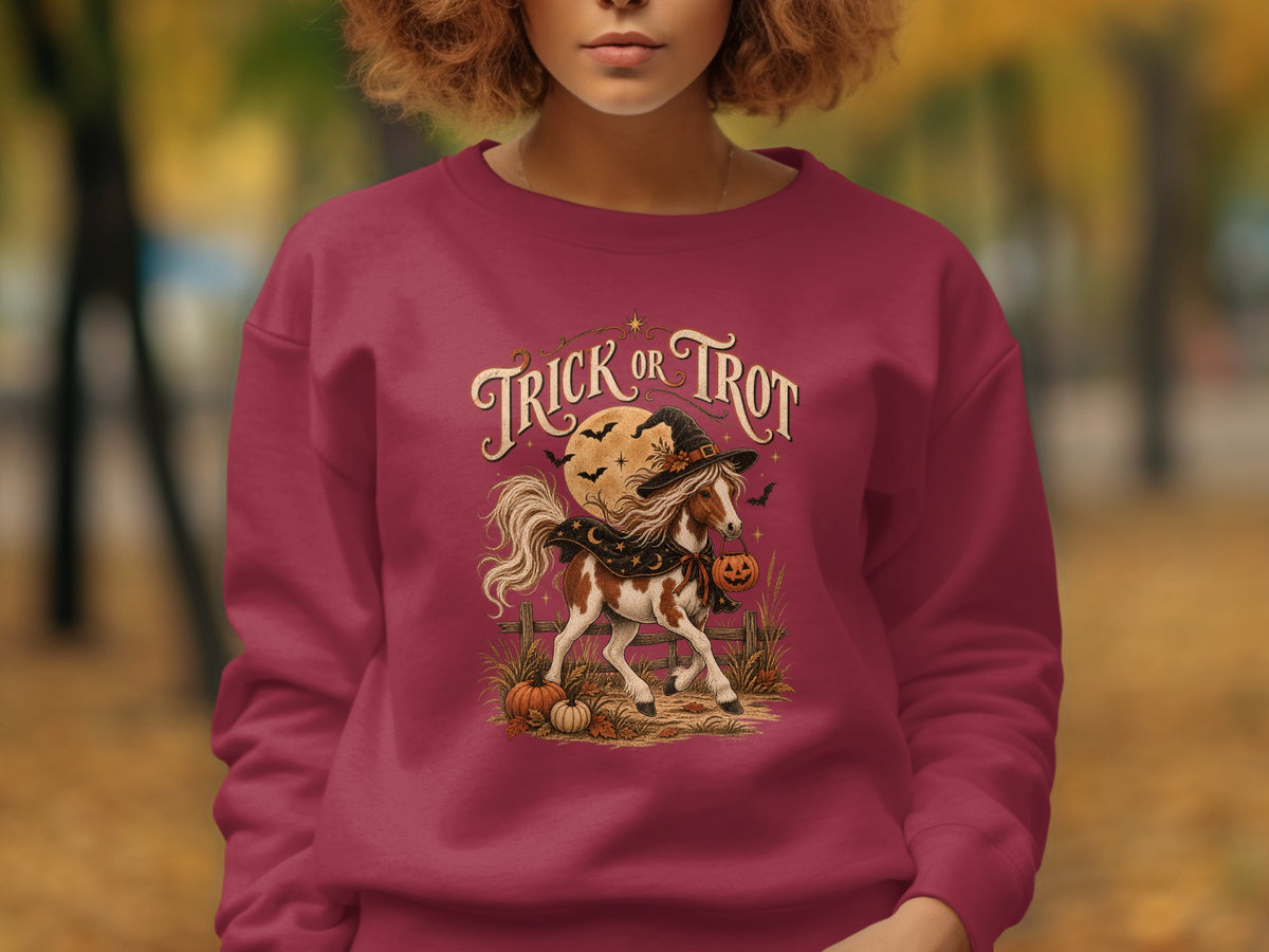 "Trick or Trot" text above a piebald horse wearing a witch hat and holding a pumpkin bucket.