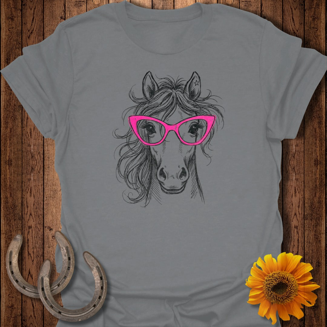 Sketch of a horse wearing pink glasses on a grey t-shirt.