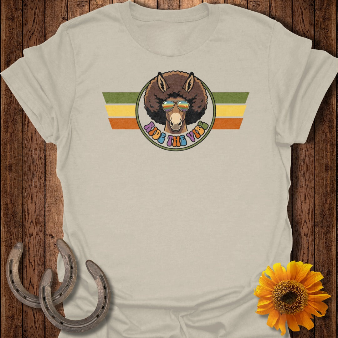 Donkey with afro and sunglasses, "ride the vibes" text, retro stripes.