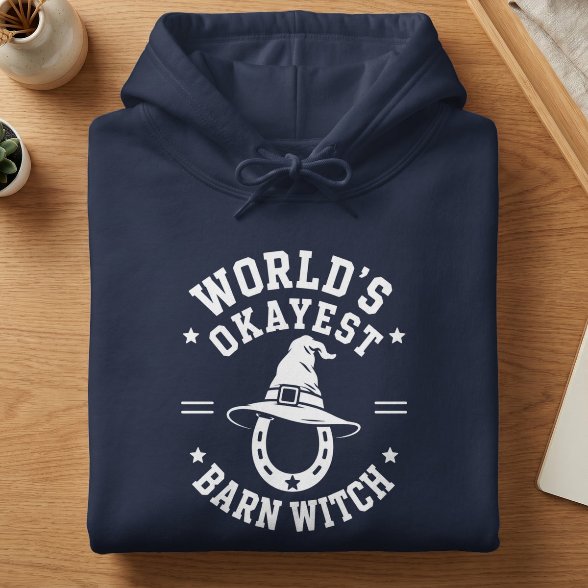 Navy hoodie with white text: "World's Okayest Barn Witch" and horseshoe witch hat graphic.