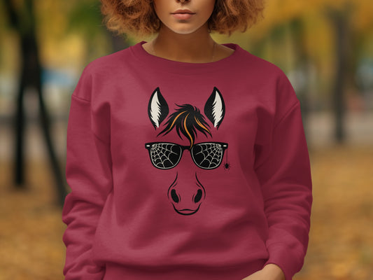 Maroon sweatshirt with horse face graphic and spiderweb sunglasses.