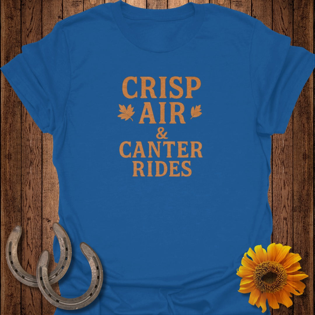 Blue t-shirt with orange text "Crisp Air & Canter Rides" and leaf graphics.