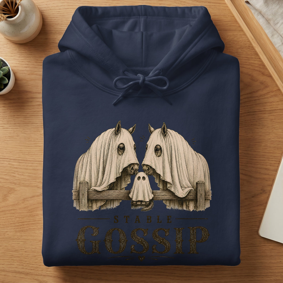 Navy hoodie with a "Stable Gossip" graphic featuring horses and a ghost.