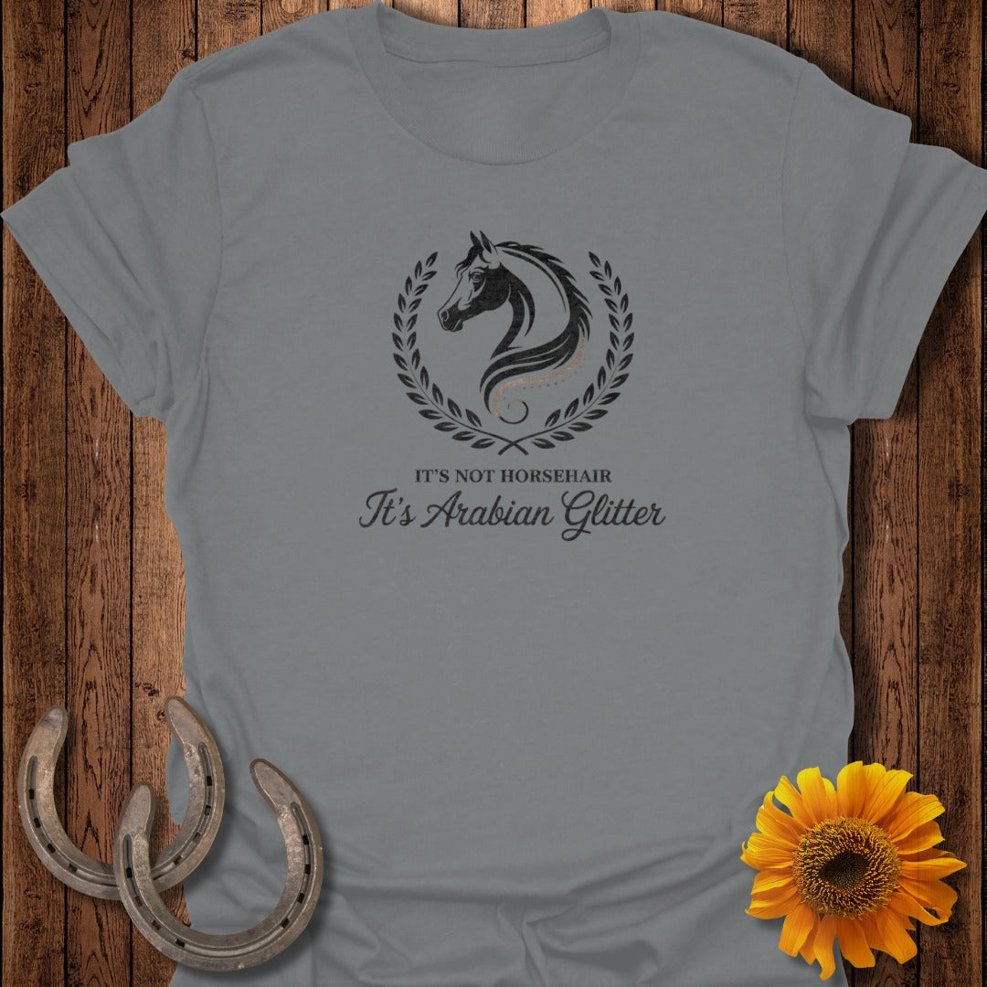 Grey t-shirt with a black horse silhouette inside a laurel wreath and the text "It's Not Horsehair It's Arabian Glitter".
