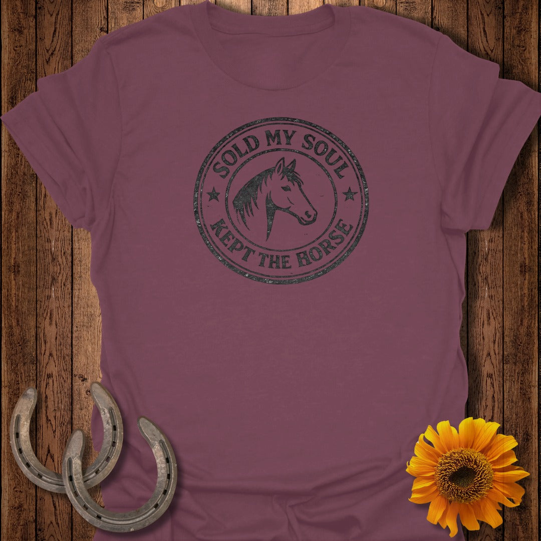 Burgundy t-shirt with a circular stamp graphic of a horse head and text.