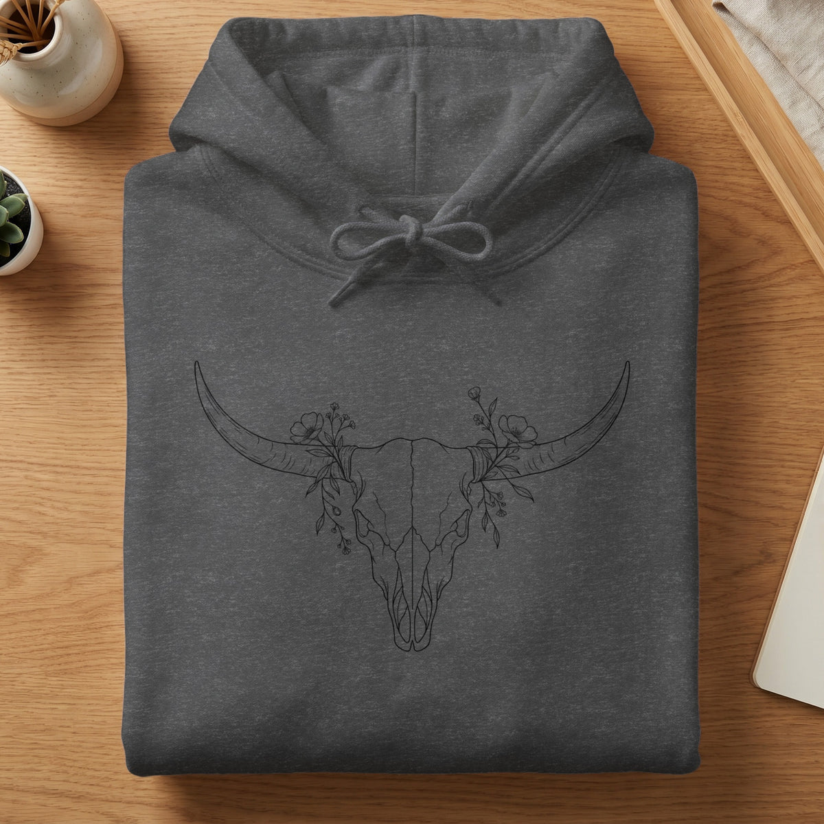Dark grey hoodie with a sketched bull skull and floral design.