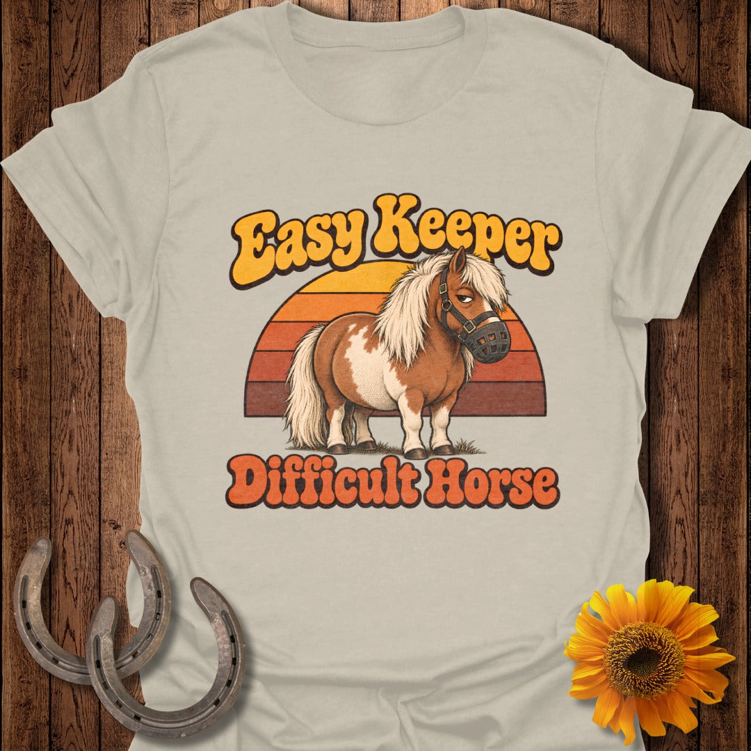 "Easy Keeper Difficult Horse" text with a cartoon horse wearing a muzzle and a sunset graphic.