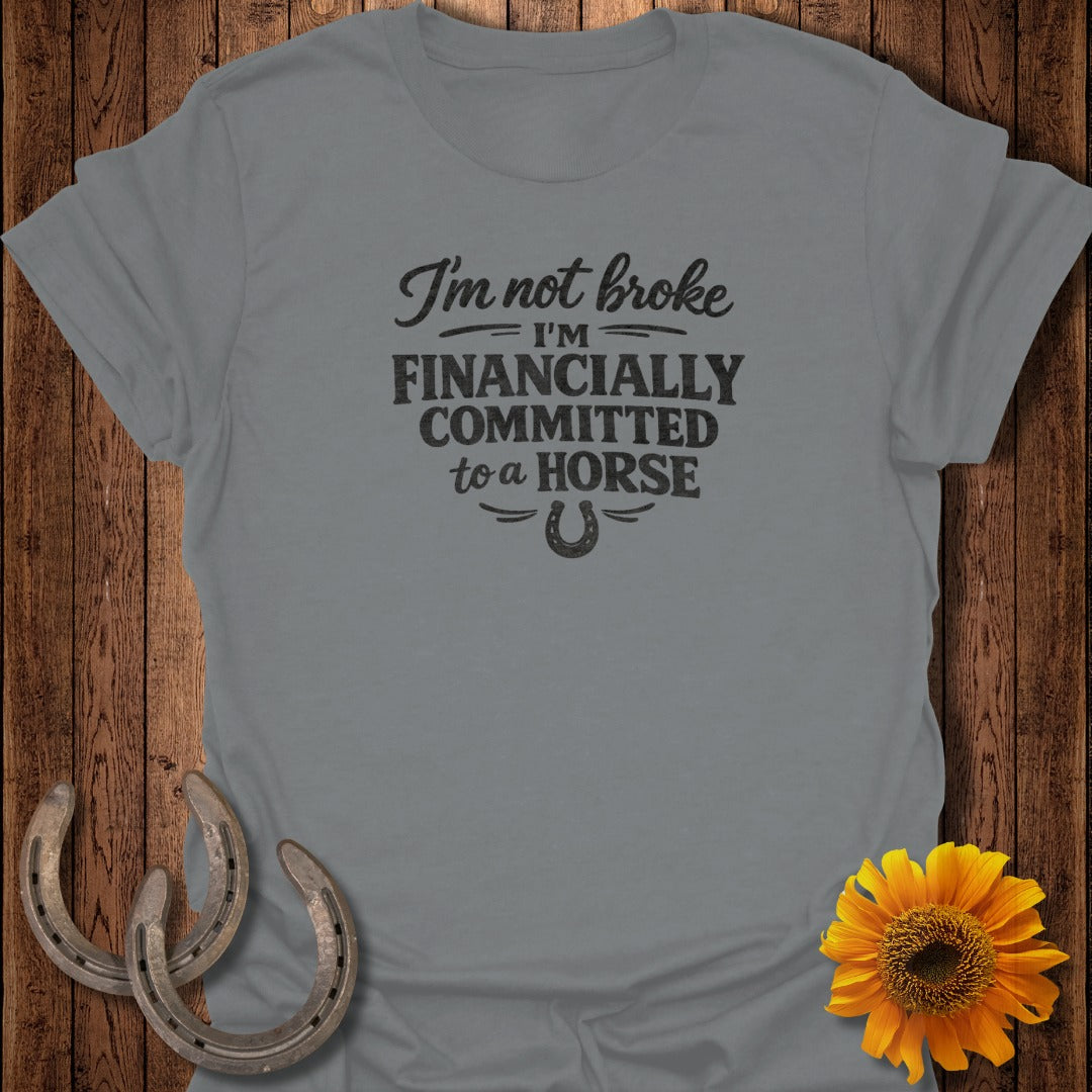 Gray t-shirt with text "I'm not broke, I'm financially committed to a horse" and horseshoe graphic.