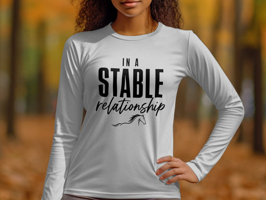 White long-sleeve shirt with "In A Stable Relationship" text and horse graphic.