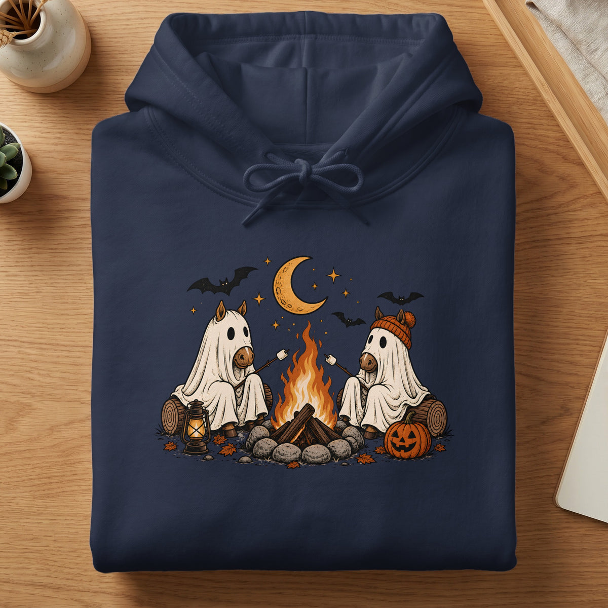 Two horses in ghost costumes roast marshmallows by a campfire under a moon.