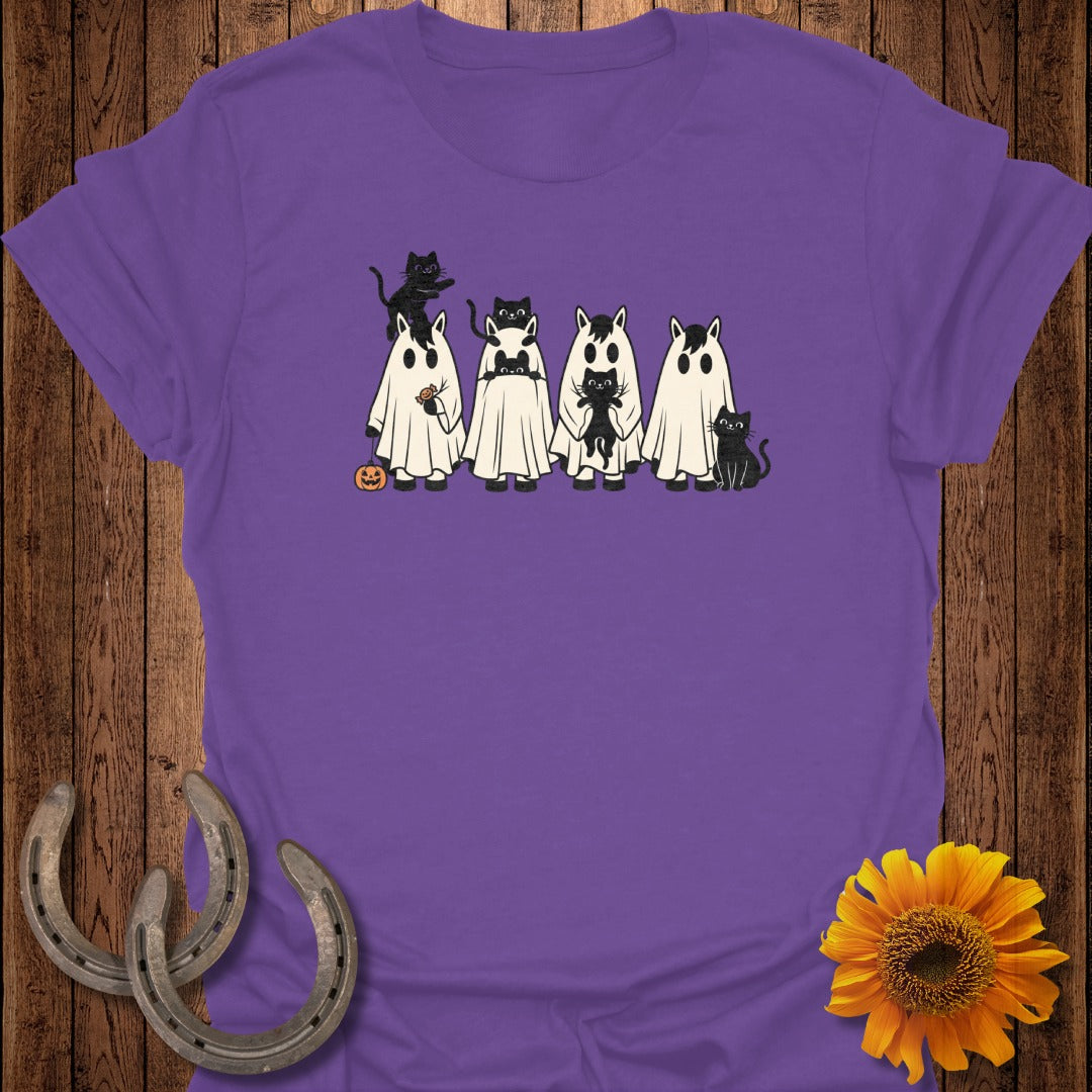 Five horses dressed as ghosts with black cats, a pumpkin, and horseshoes.
