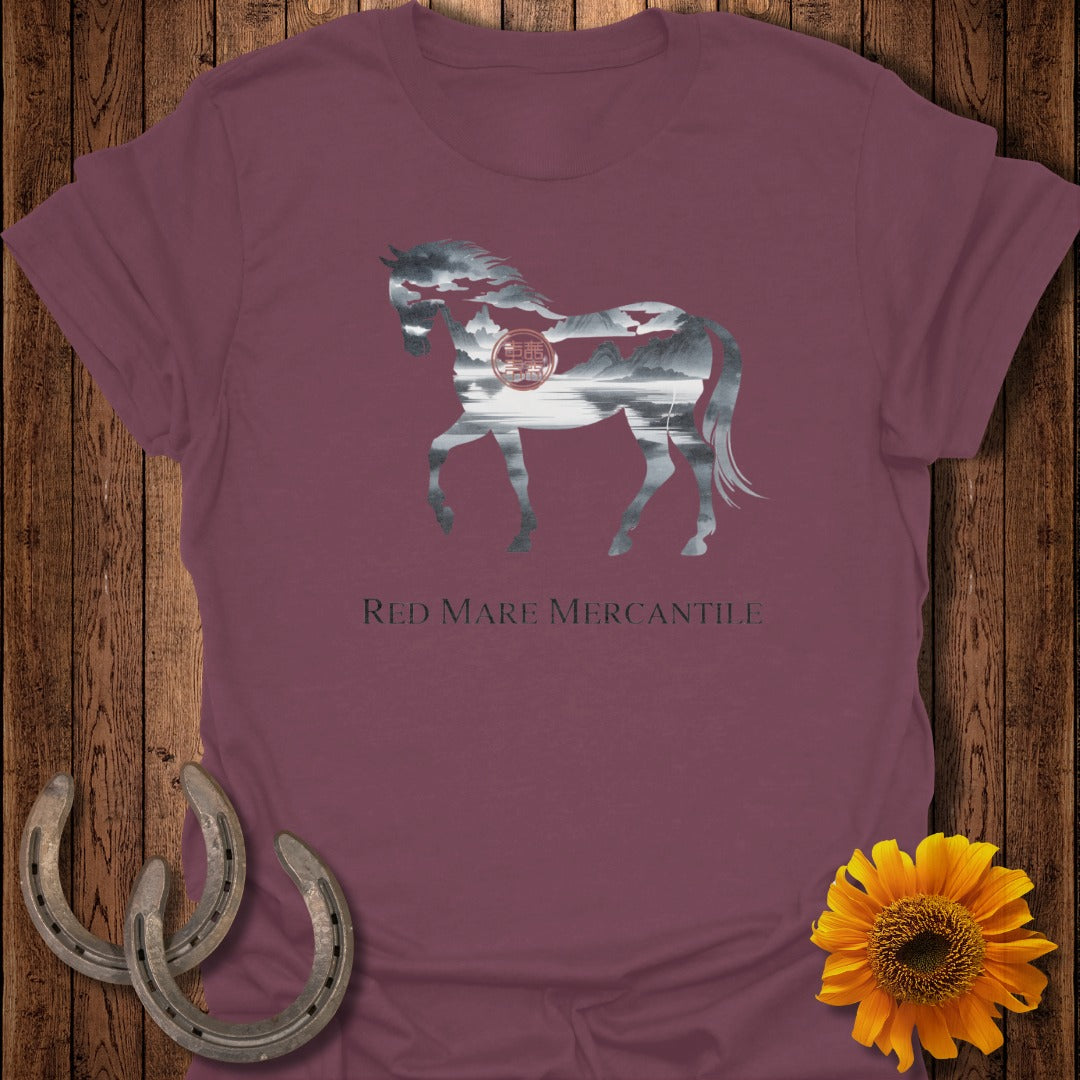 Burgundy t-shirt with a silhouette of a horse filled with a mountain landscape and Red Mare Mercantile text.