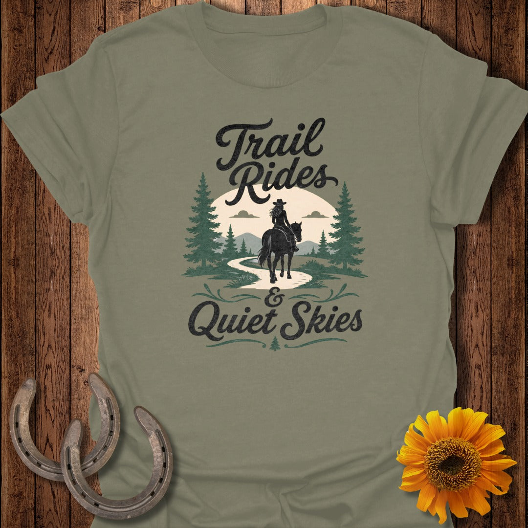 Olive green t-shirt with "Trail Rides & Quiet Skies" text and a rider.