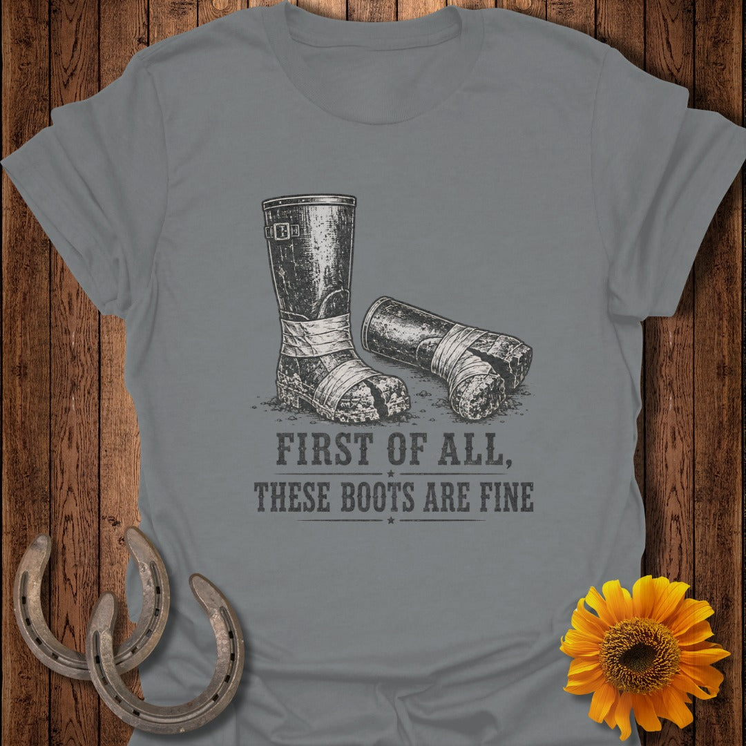Grey t-shirt with graphic of worn, taped boots and text.
