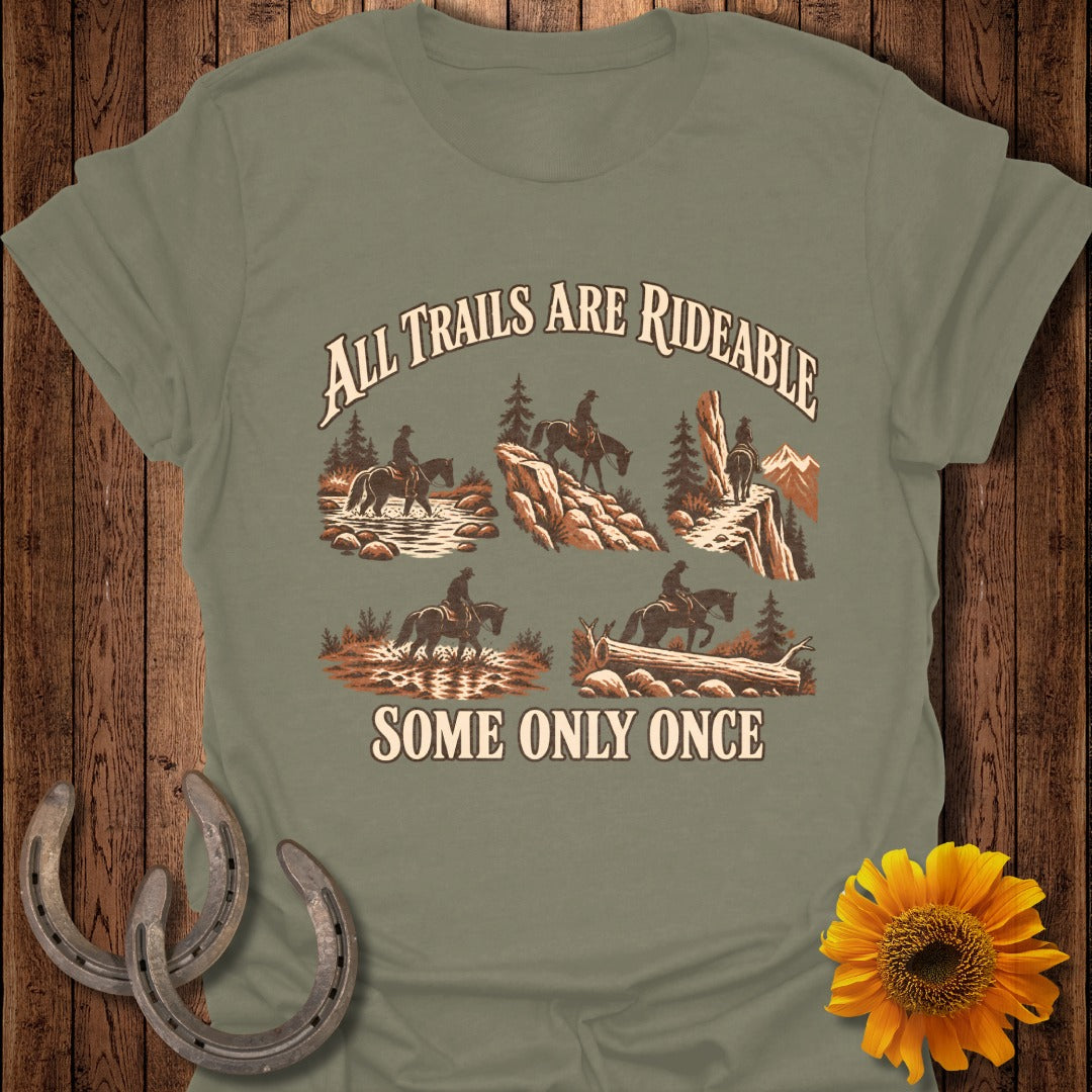 Graphic with cowboys riding horses through varied terrains, text "All Trails Are Rideable Some Only Once".