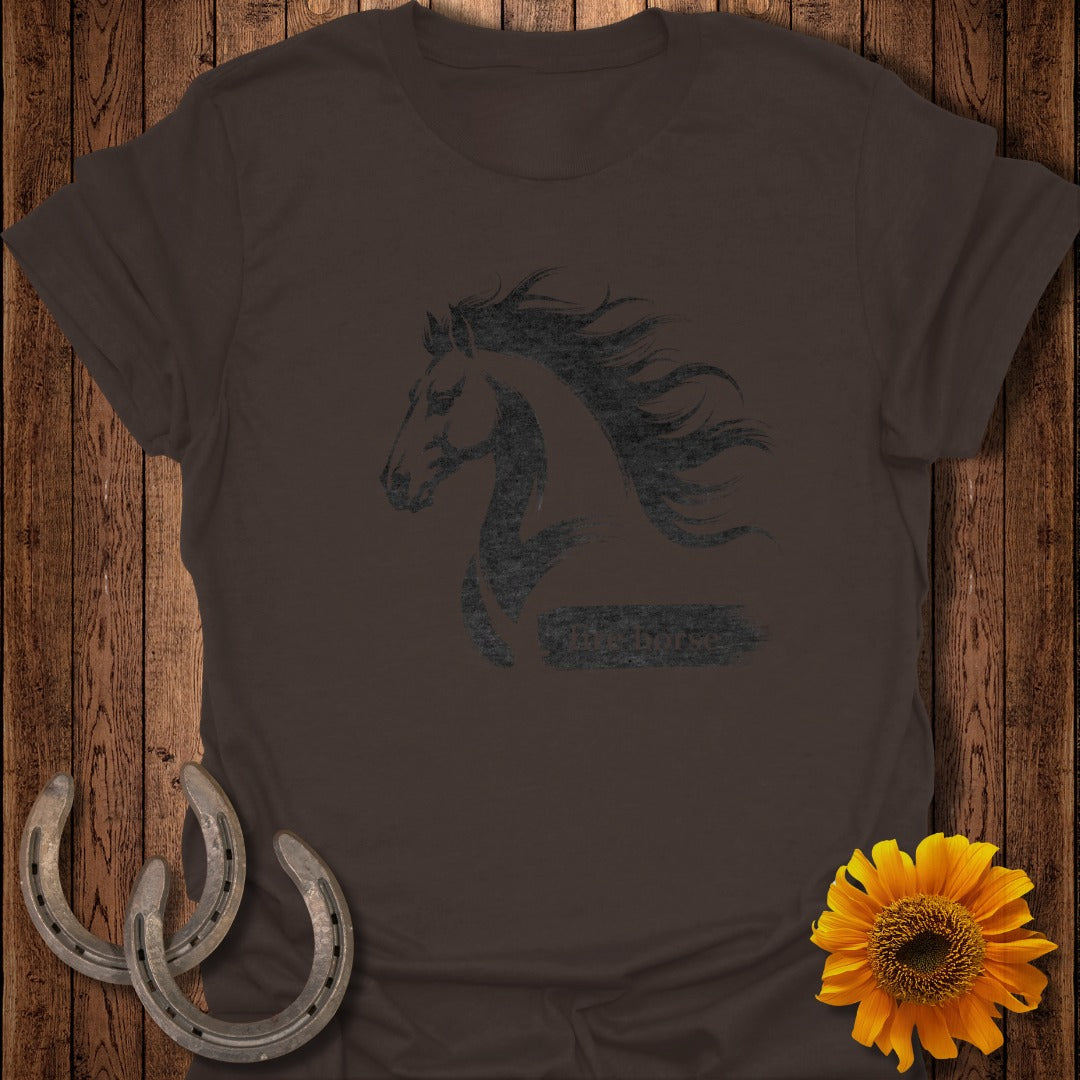 Dark brown t-shirt with distressed horse graphic and text overlay.