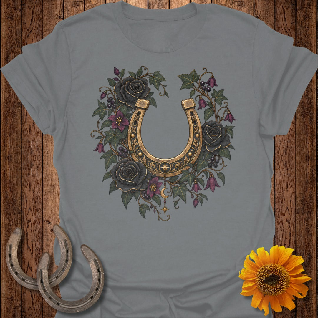 Gray t-shirt with golden horseshoe, black roses, and celestial charms graphic.