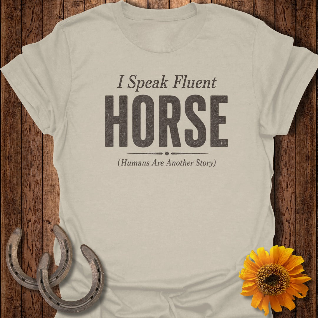 Light tan t-shirt with "I Speak Fluent HORSE (Humans Are Another Story)" text.