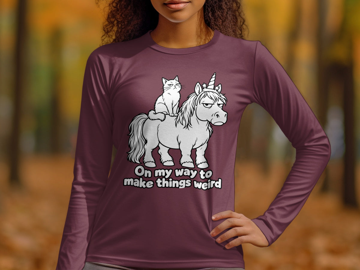 Cat riding a grumpy unicorn with the text "On my way to make things weird."