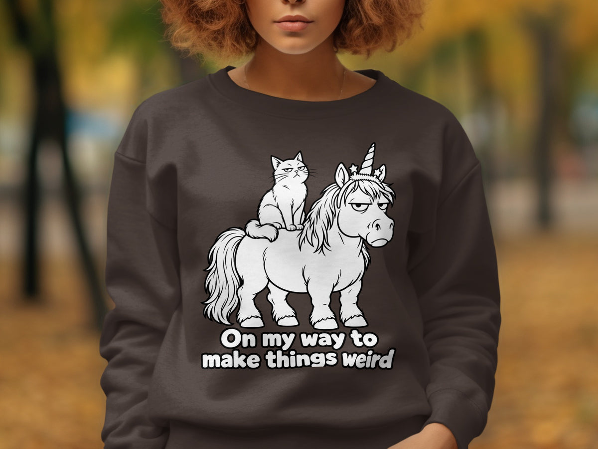 Cat riding a grumpy unicorn with text "On my way to make things weird".