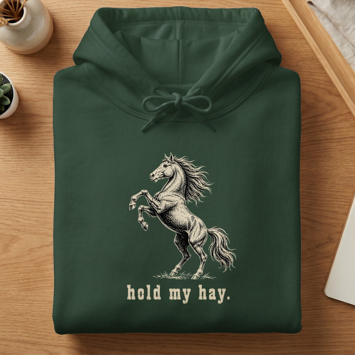 Green hoodie with a rearing horse graphic and "hold my hay." text.