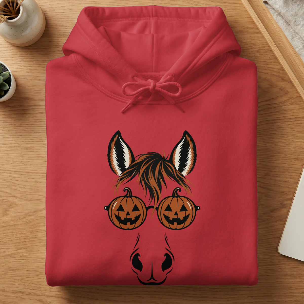 Red hoodie with a horse face graphic wearing pumpkin glasses.